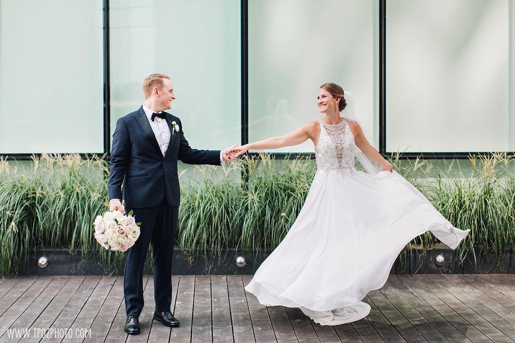 A groom twirling his bride at the Four Seasons Baltimore wedding